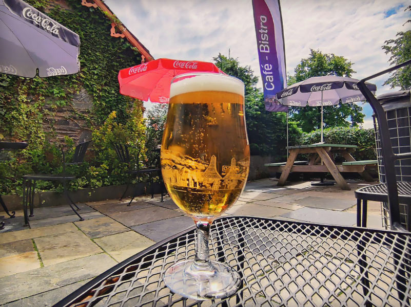 A pint of Beer sitting on a table in Scotland